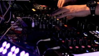 A DJ mixes dance music at a club
