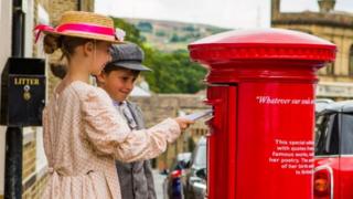 Children from Thornton Primary post letters in the Emily Bronte commemorative postbox