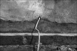 A hose bringing fresh water into the home of a family living near the abandoned plant