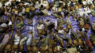 Migrants believed to be Rohingya rest inside a shelter after being rescued from boats at Lhoksukon in Indonesia's Aceh Province on 11 May 2015
