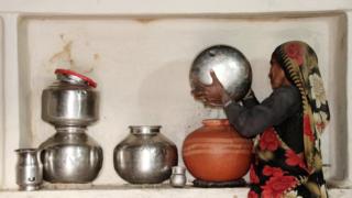 महिला पानी भरते हुए