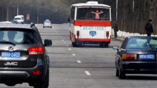 A child looks through the rear window of a bus in Pyongyang, North Korea April 16, 2017.