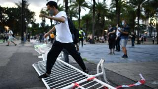 A man steps over a barricade which had been set up to block access to Victoria Park in Hong Kong on June 4, 2020