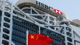 A Chinese national flag flies in front of HSBC headquarters in Hong Kong.