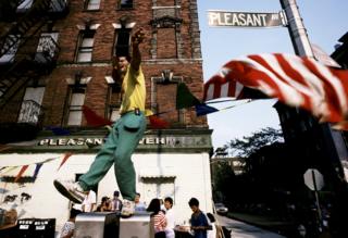A man dances on bin