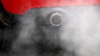 A car exhaust emits fumes