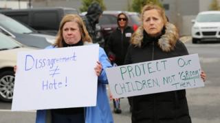 Two protesters outside the drag queen story time event