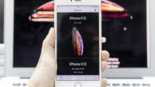 A man using an Apple Store app to pre order the new iPhone Xs on September 14 2018 in Hong Kong, Hong Kong.
