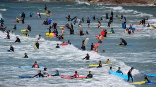 Surfers in Polzeath, Cornwall