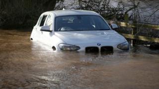 A car submerged in water after the River Eden burst its banks near Carlisle