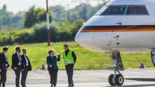 Angela Merkel pictured with the plane before it was damaged