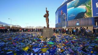 Cardiff City with flowers surrounding stadium and statue