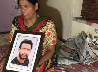 Lakshmi Devi with a photo of her son