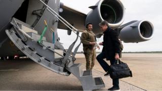 Secretary of State Antony Blinken boards a plane for departure, April 23, 2022