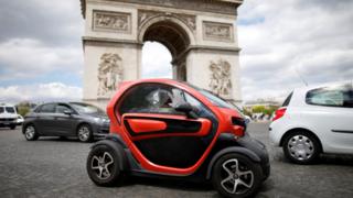 An electric car from Renault, drives past the Arc de Triomphe in Paris on 30 May 2017
