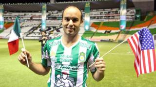 Landon Donovan posa con dos banderas