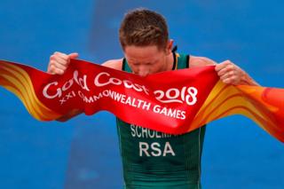 South Africa's Henri Schoeman celebrates winning the men's triathlon final