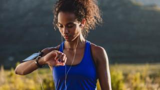 Technology Woman checking fitness tracking watch