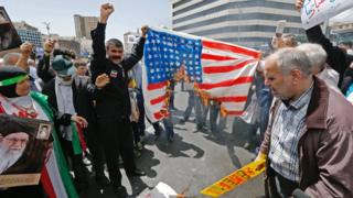Iranian protesters burn a painted US flag at a rally in Tehran on 10 May 2019