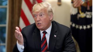 U.S. President Donald Trump answers questions during a meeting with military leaders