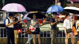 People WAIT at a bus  during a Wetroom brought by SuperTyfon  in Taipei, Minkwo, 08 August 2019