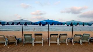 Empty chairs at a Thai beach