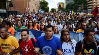 Students demonstrate against the government of Venezuelan President Nicolas Maduro in the streets of Caracas, 3 November 2016