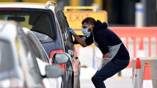 NHS workers check people at a coronavirus drive-through testing station set up at the Wembley IKEA store for NHS staff - 1 April 2020