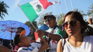 People sing the Mexican national anthem during the opening ceremony of the sixth annual Mole Fair on October 6, 2013 in Los Angeles, California.