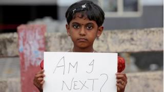 girl holds a placard during a protest against the rape of an eight-year-old girl in Kathua, near Jammu, in Kochi, India April 15, 2018.
