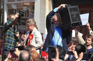 Labour leader Jeremy Corbyn holds up a speaker so the crowd can hear a speech by the party's local candidate Rachael Maskell during a rally in St Helen's Square, York on 10 May 2017.