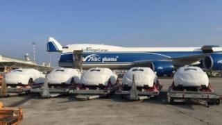 Five Maserati seen at the Port Moresby Airport, draped in white protective covers