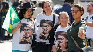 Jair Bolsonaro's supporters gathered in front of the Albert Einstein Hospital in Sao Paolo, wearing t-shirts with printed faces