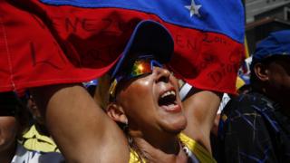 A woman shouts slogans as opposition leader and self-proclaimed interim president of Venezuela Juan Guaido gives a speech