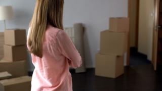 woman standing next to boxes