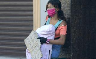 Woman with baby begging in Guayaquil, 16 Apr 20