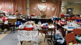 Belongings such as helmets and food are left in a room