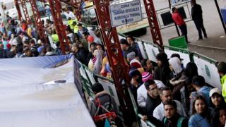 Venezuelan migrants stand in line to register their exit from Colombia before entering Ecuador, at the Rumichaca International Bridge in Colombia August 17, 2018