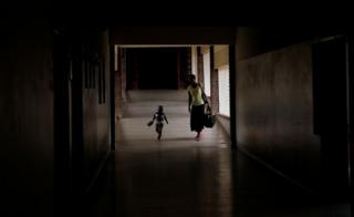A mother and child arrive for treatment at a local government hospital in Harare, Zimbabwe, 4 February 2020