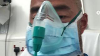 Simon Lo in hospital wearing an oxygen mask