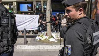 French officers pay tribute to officer killed on the Champs Elysees in Paris, 21 April 2017