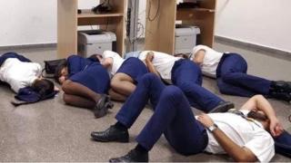 Six men in Renoir's uniform are sleeping on the floor of an airport in Malaga, Spain.