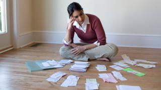 woman surrounded by receipts