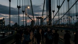 Protesters defy a curfew to walk over New York's Manhattan Bridge, 2 May 2020