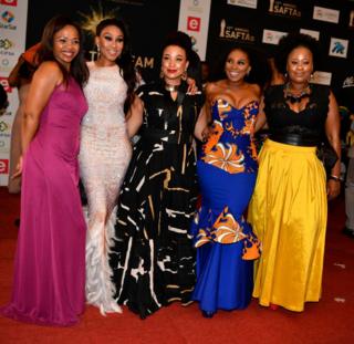 Five women stand together on the red carpet at the South African Film and Television Awards (SAFTAs) at the Sun City Superbowl on 2 March 2019, in Rustenburg.