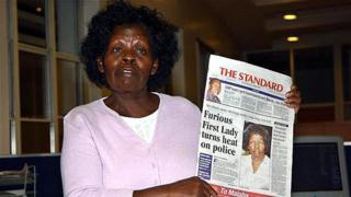 Kenya's First Lady Lucy Kibaki speaks to the media while holding a copy of a local newspaper with the headline 'Furious First Lady turns heat on police' at Nation Media Centre in downtown Nairobi early 03 May 2005. The First Lady, irritated by stories published in the local media about her family, stormed the newspaper offices late 02 May where she held a marathon press conference lasting until nearly 5am in the morning