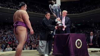 Donald Trump prepares to present the President's Cup to wrestler Asanoyama, winner of the Summer Grand Sumo Tournament at Ryogoku Kokigikan Sumo Hall in Tokyo, Japan May 26, 2019
