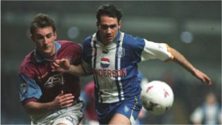 Guy Whittingham of Sheffield Wednesday (right) holds off Riccardo Scimeca (left) of Aston Villa