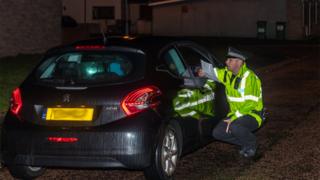 Police officer talking to driver
