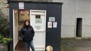 Sue Emmanuel outside honesty shop